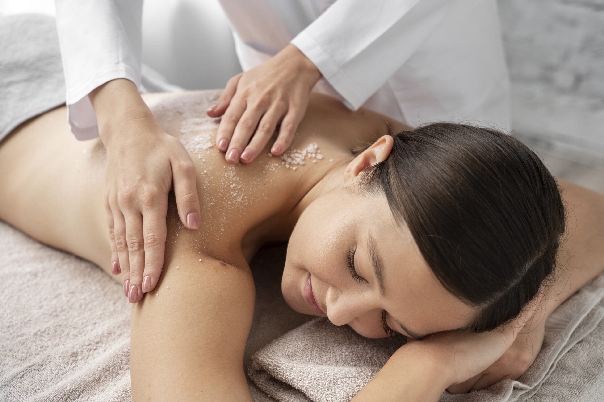 woman receiving body polish treatment