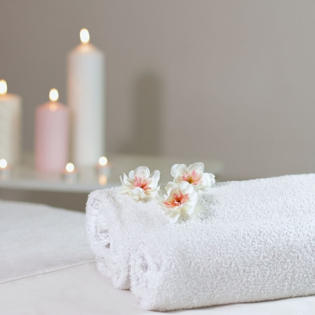 rolled up towels and flowers