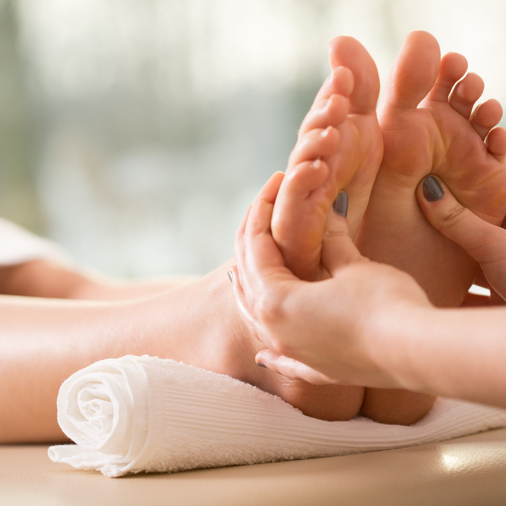 Close-up of young woman having reflexology